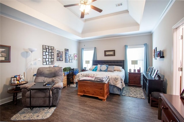 bedroom featuring ceiling fan, dark hardwood / wood-style floors, a raised ceiling, and crown molding