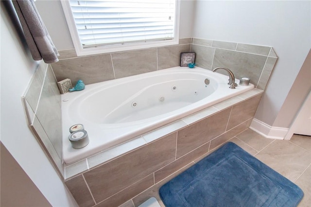 bathroom featuring tile patterned floors and tiled bath