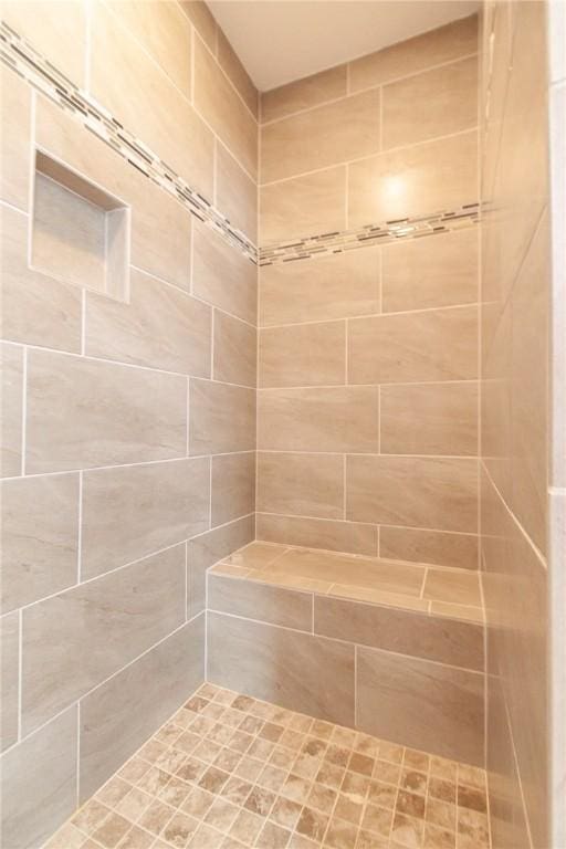 bathroom with a tile shower