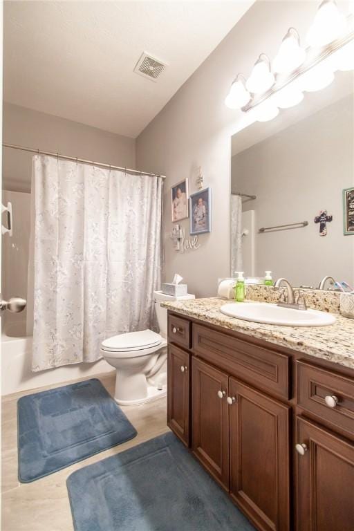 full bathroom with shower / bath combo, vanity, and toilet