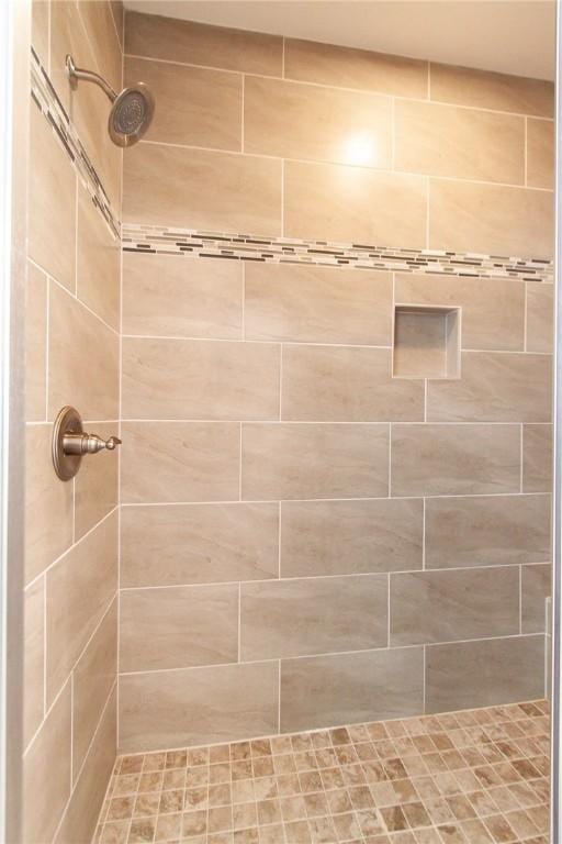 bathroom with tiled shower