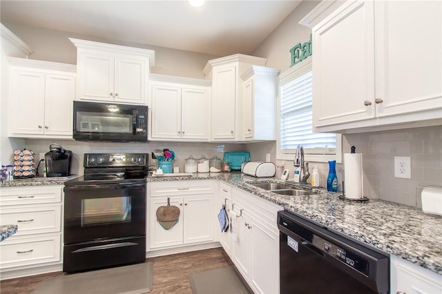 kitchen featuring decorative backsplash, white cabinetry, sink, and black appliances