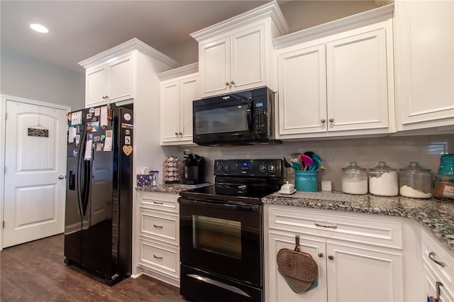 kitchen with white cabinets, dark hardwood / wood-style floors, light stone counters, and black appliances