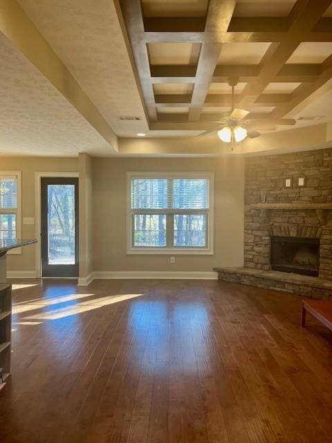 unfurnished living room featuring hardwood / wood-style flooring, a fireplace, and baseboards