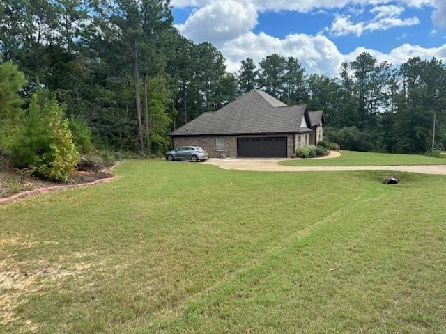 view of home's exterior featuring concrete driveway, a lawn, and an attached garage