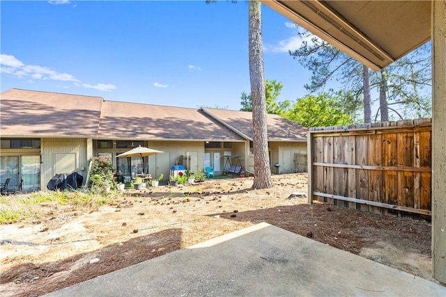 view of yard with fence and a patio
