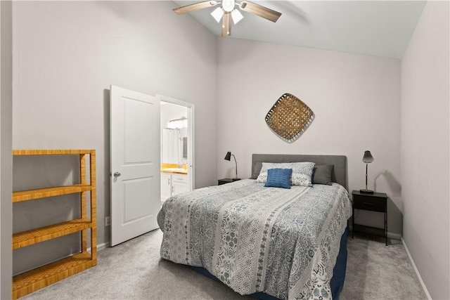 carpeted bedroom with connected bathroom, baseboards, ceiling fan, and lofted ceiling