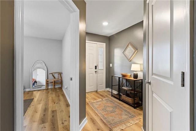 foyer entrance featuring baseboards, recessed lighting, and light wood-style flooring