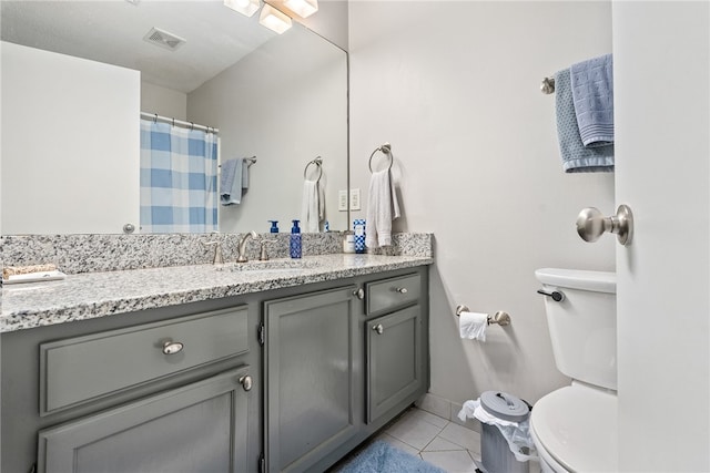 1041 Stonegate Dr Unit C, Auburn, AL 36830 - full bathroom with toilet, vanity, tile patterned floors, and baseboards