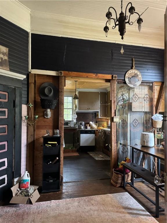 interior space with dishwasher, wood-type flooring, and a chandelier