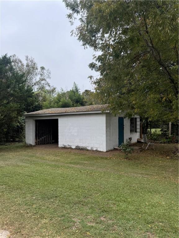 view of outbuilding with a lawn