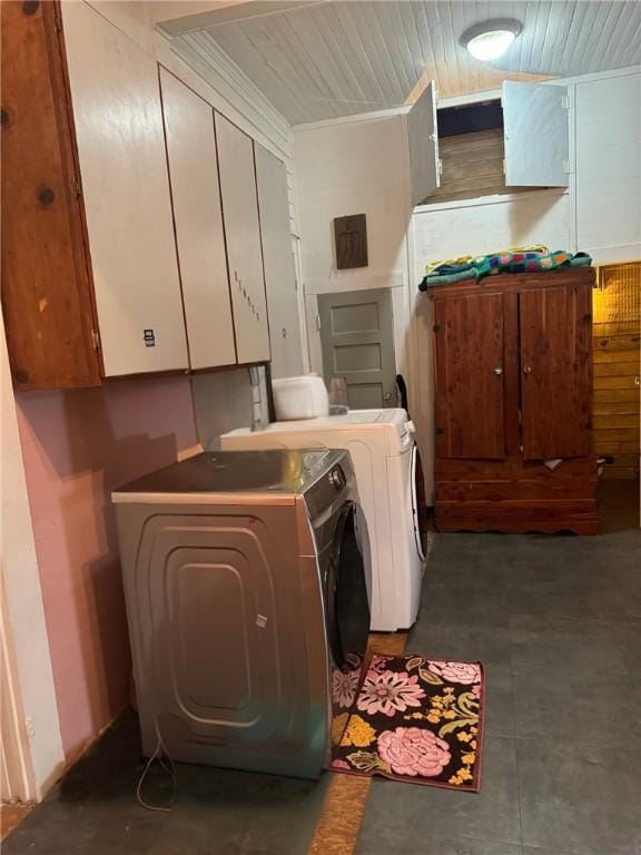 laundry room featuring wood ceiling, cabinets, and washer and clothes dryer