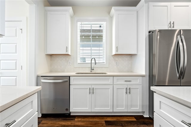 854 Village Dr, Opelika, AL 36801 - kitchen featuring stainless steel appliances, tasteful backsplash, white cabinetry, and light countertops