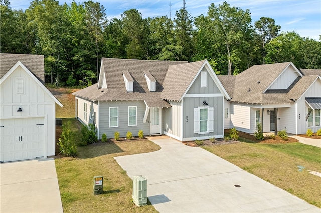 854 Village Dr, Opelika, AL 36801 - view of front of home featuring board and batten siding, driveway, a front lawn, and roof with shingles
