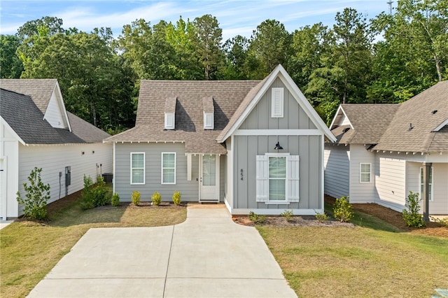 854 Village Dr, Opelika, AL 36801 - view of front of property featuring board and batten siding, a front yard, and roof with shingles
