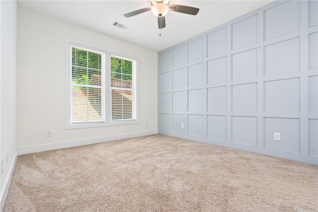 854 Village Dr, Opelika, AL 36801 - unfurnished room featuring carpet, a ceiling fan, and a decorative wall