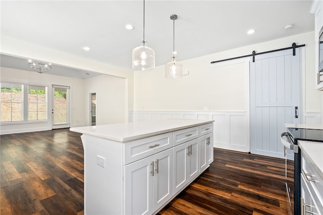 854 Village Dr, Opelika, AL 36801 - kitchen featuring stainless steel range with electric stovetop, a barn door, dark wood-type flooring, recessed lighting, and light countertops