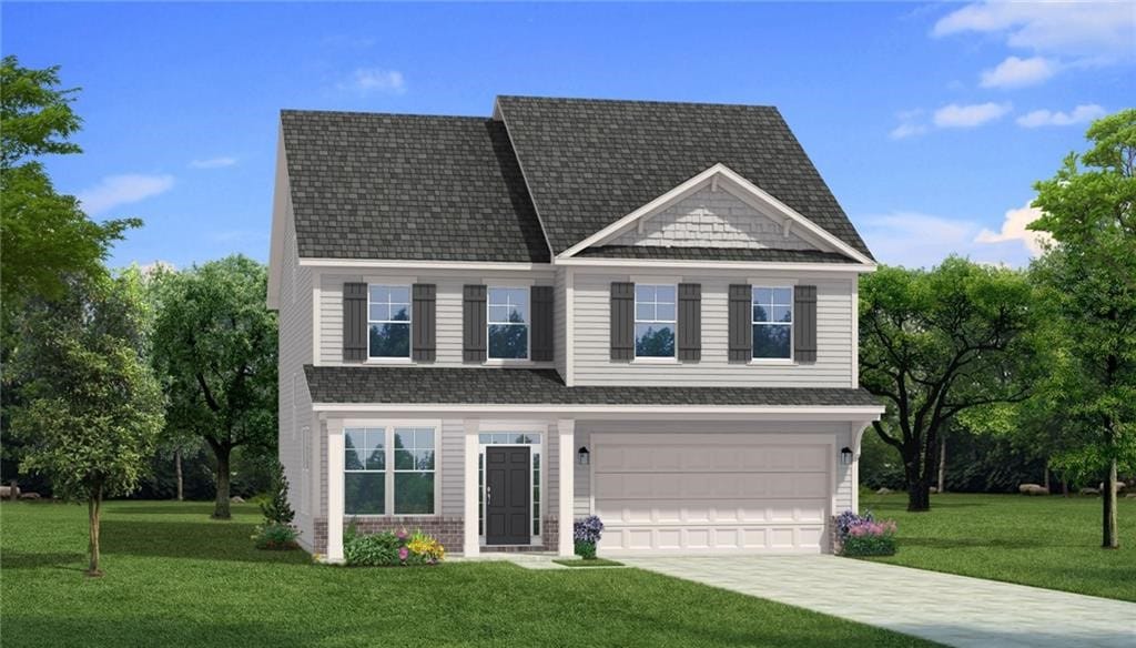 view of front of property with a front yard and a garage