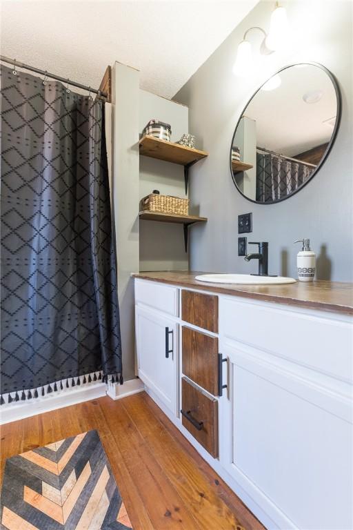 bathroom with vanity and wood-type flooring