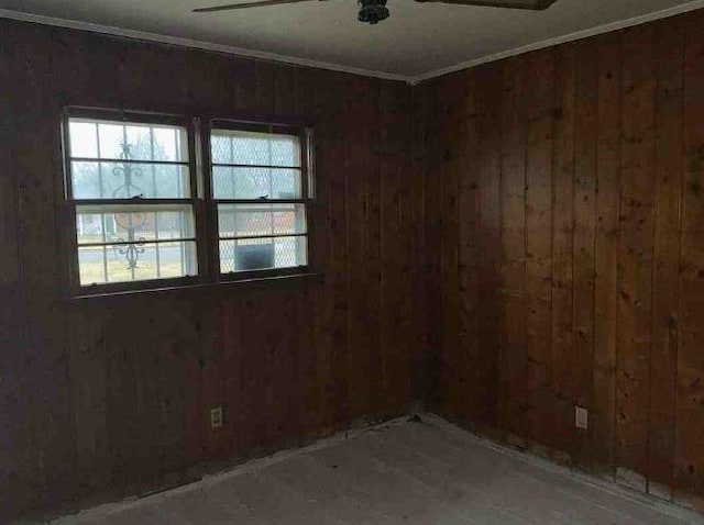 spare room with wooden walls and ornamental molding