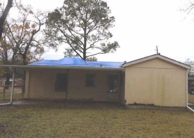 rear view of house with a yard