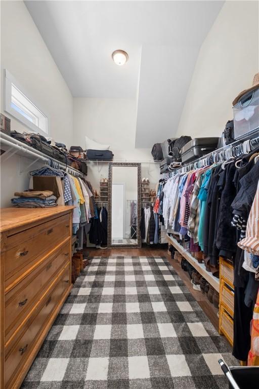 walk in closet with lofted ceiling