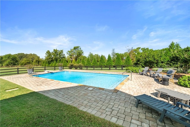 view of pool with a lawn and a patio