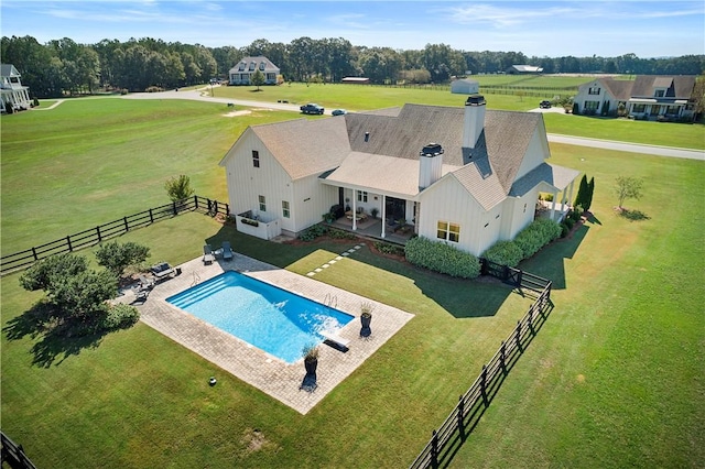 view of swimming pool with a lawn and a patio