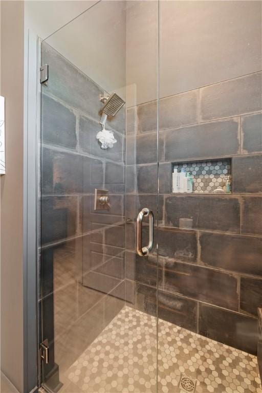 bathroom featuring tile patterned flooring and an enclosed shower