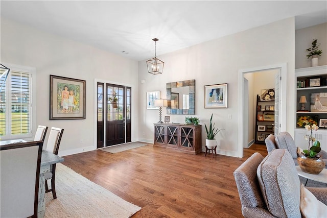 dining area featuring hardwood / wood-style flooring and an inviting chandelier