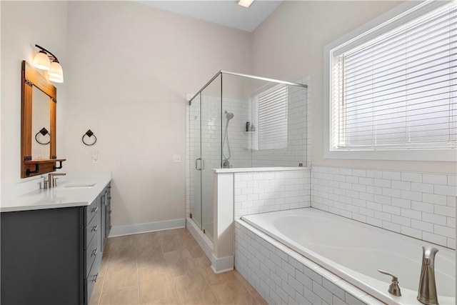 bathroom with shower with separate bathtub and vanity