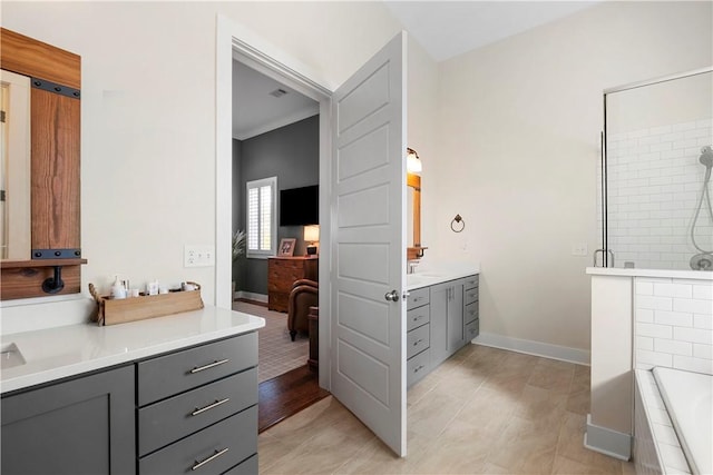 bathroom featuring shower with separate bathtub, vanity, and tile patterned floors