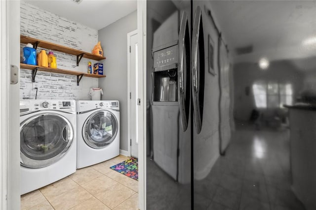 laundry room with light tile patterned flooring, laundry area, and separate washer and dryer