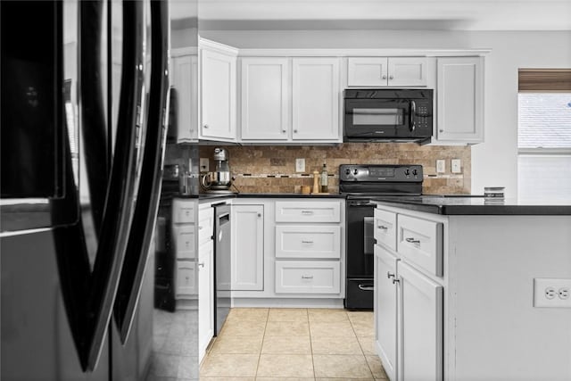 kitchen featuring light tile patterned floors, black appliances, white cabinetry, dark countertops, and tasteful backsplash