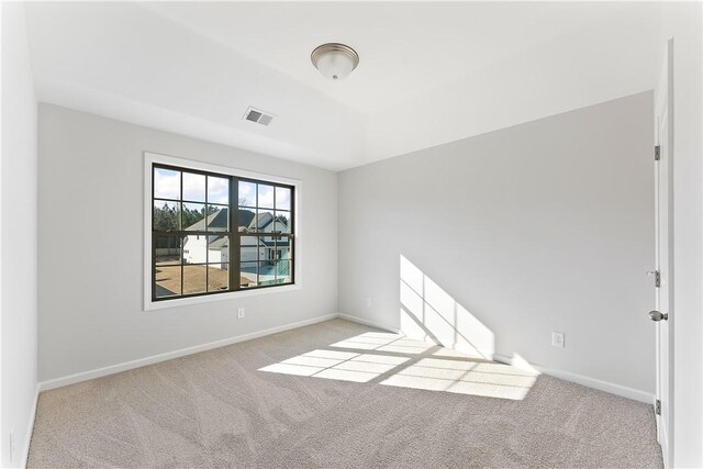 empty room featuring light carpet