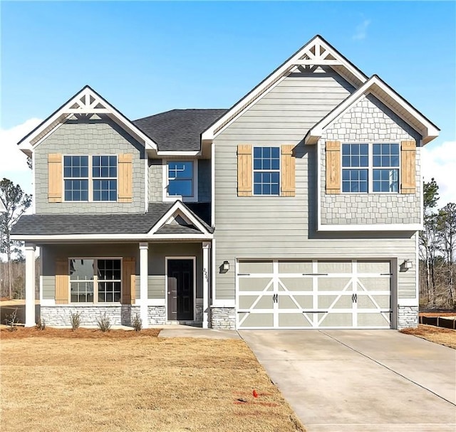 craftsman-style home featuring a garage and a front yard