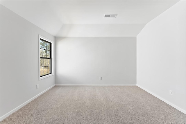 unfurnished room with carpet floors and lofted ceiling