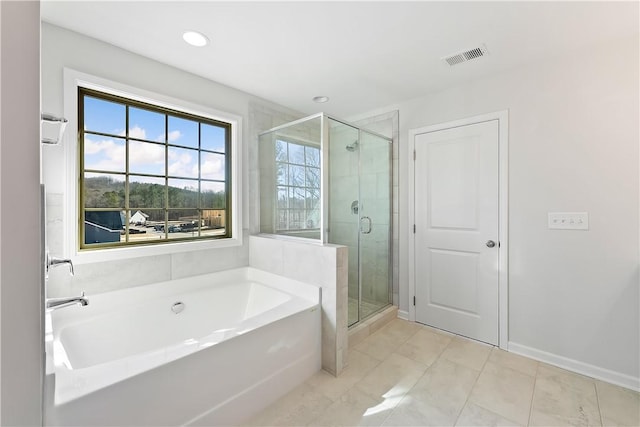 bathroom featuring separate shower and tub