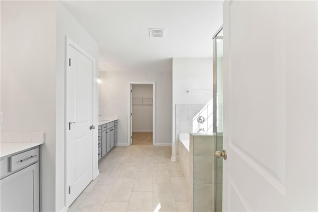 bathroom with vanity, independent shower and bath, and tile patterned flooring