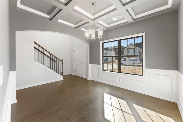 interior space with coffered ceiling, a chandelier, beam ceiling, and dark hardwood / wood-style flooring