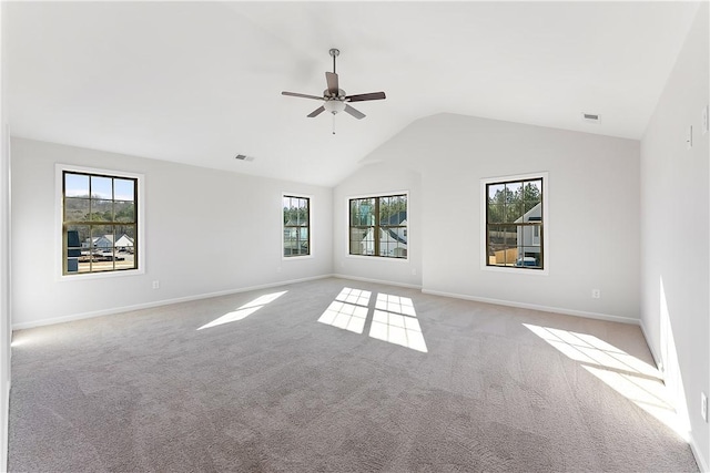 empty room featuring ceiling fan, light carpet, and vaulted ceiling