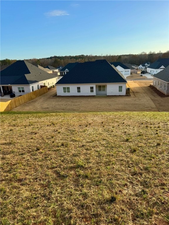 rear view of house with a yard