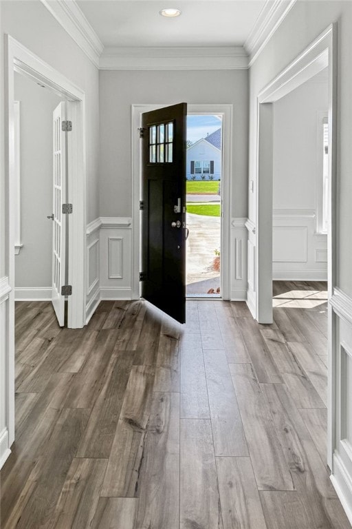 foyer with hardwood / wood-style flooring and ornamental molding