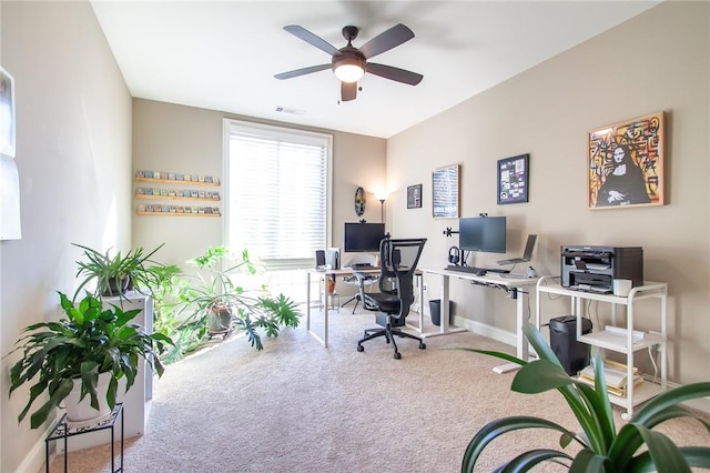 home office with ceiling fan and carpet