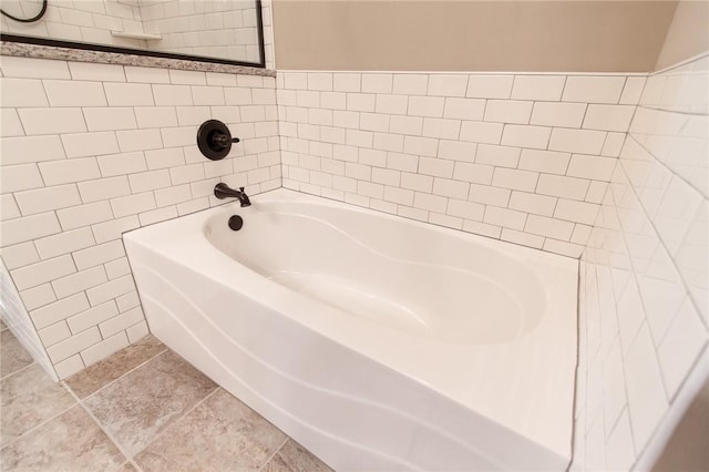 bathroom with tile patterned flooring and a bathing tub