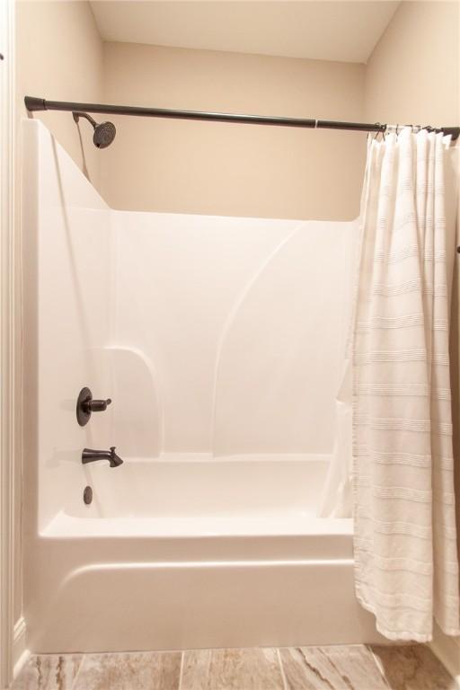 bathroom featuring shower / bathtub combination with curtain