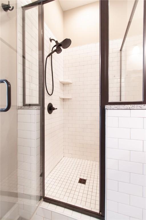 bathroom featuring a shower with door