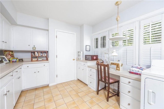 406 Saint Francis Rd, Eufaula, AL 36027 - kitchen featuring washer / clothes dryer, light countertops, white cabinets, and pendant lighting