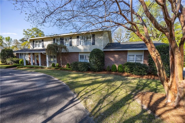 406 Saint Francis Rd, Eufaula, AL 36027 - view of front of home featuring brick siding, a porch, and a front lawn