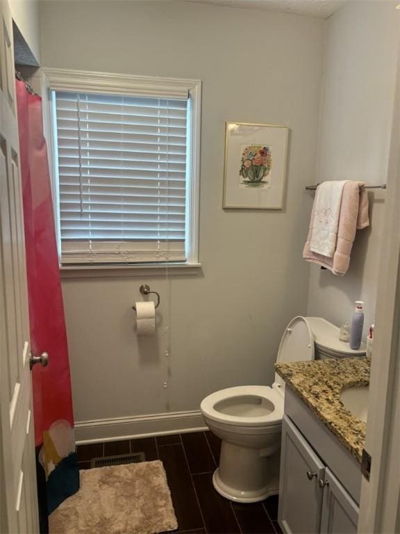 522 Oak Meadow Ln, Auburn, AL 36830 - bathroom featuring vanity, toilet, and baseboards
